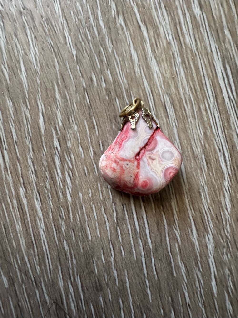 Red Freeform stone pendant with gold tone bail